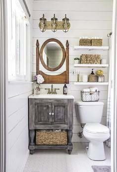 the bathroom is decorated in white and has an old fashioned vanity with mirror above it