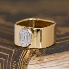 a close up of a ring on top of a book with a diamond in it