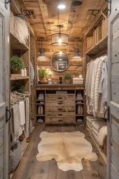 an open closet with lots of clothes and rugs on the floor, along with wooden walls