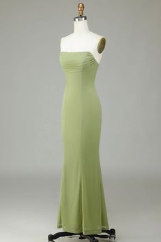 a dress on a mannequin with a dummy in the back and an object behind it