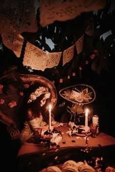 a table topped with candles and plates covered in doily