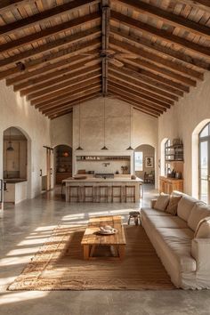 a large open living room with wooden beams