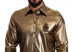 DOLCE & GABBANA Gorgeous, 100% Authentic Dolce & Gabbana shirt with DG stamp embroidery on the chest. It features a spread collar, back yoke and box pleat. One-button cuffs. Model: Long sleeve collared shirt Fitting: Regular fit Material: 67% Acetate 33% Silk Colour: Gold Full front button closure Logo details Made in Italy This item has a minor defect, it has a minor stain on the collar (see pictures for details). Luxury Gold Formal Shirt, Luxury Gold Collared Shirt, Gold Long Sleeve Shirt With Buttons, Elegant Gold Button-up Tops, Stamp Embroidery, Gold Silk Long Sleeve Shirt, Long Sleeve Collared Shirt, Collared Shirt, Box Pleats