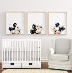 a baby's room with three framed pictures on the wall