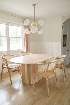 a dining room table with four chairs around it