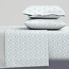 three sheets and two pillow cases stacked on top of each other