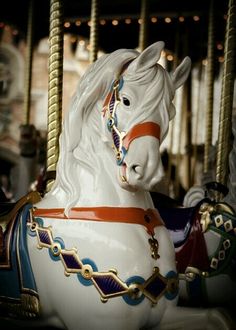 a close up of a merry go round horse