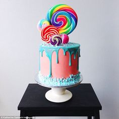 the cake is decorated with candy and lollipops on it's top