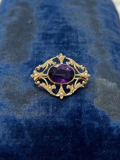 "Art Nouveau Style 14k Yellow Gold Brooch or Pin with Amethyst Gemstone and Seed Pearls 585 Victorian Style Here we have a fabulous brooch or pin modeled in 14k yellow gold fit with a large Amethyst gemstone in the center accented on all sides by scrolling filigree and delicate graduated seed pearls. The brooch is in excellent overall condition with no wear to note. The brooch is marked 14k on the pin catch as well as the body of the brooch itself.  The amethyst is secure in its bezel setting an Gold Brooch, Art Nouveau Style, Gold Brooches, Seed Pearl, Amethyst Gemstone, Victorian Style, Victorian Fashion, Bezel Setting, Brooch Pin