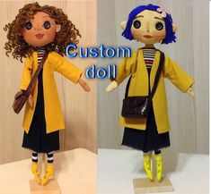 the doll is wearing a yellow coat and black dress with striped socks, carrying a brown purse