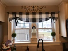 a kitchen window with a black and white checkered valance