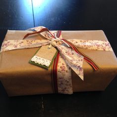 a present wrapped in brown paper and tied with ribbon