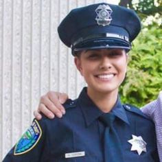 two police officers are posing for a photo