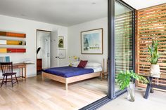 a bedroom with wooden floors and white walls