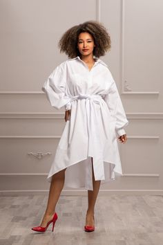 Introducing our White Extravagant Shirt Dress, the epitome of summer sophistication and style. Crafted from premium, breathable cotton, this dress ensures comfort while making a bold fashion statement. Designed to offer a chic and elegant look, perfect for transitioning from day to night events. Functional and fashionable, the oversized front pockets add a unique touch to the dress, providing practicality without compromising on style. The high collar adds a touch of drama and refinement, settin Elegant Knee-length Shirt Dress For Brunch, Elegant Midi Length Shirt Dress For Brunch, White Knee-length Shirt Dress For Dress Down Occasion, White Knee-length Shirt Dress For Dress Down, White Knee-length Shirt Dress For Party, White Formal Shirt Dress For Summer, Elegant White Shirt Dress For Daywear, White Long Sleeve Shirt Dress, Dress Extravagant