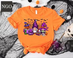 Halloween Gnomes Shirt, Halloween Tshirt, Funny Halloween Gifts, Halloween Gnomies T-Shirt, Halloween Funny Shirt, Spooky Season T-shirts ---HOW TO ORDER--- 1-) Please, check and review all photos 2-) Choose your t-shirt size and color *Different styles of shirts may have different shades of same color choice due to different manufacturer brands. *For this reason, we recommend you to match shirts from the same styles if you want precisely matching colors (exa. Unisex,V-neck, Tank top, etc.). 3-) Click add to cart. You can go back to add more product 4-)Click "Proceed to check out" 5-)When you check out, you can add a note to seller for any request ---We make DTF printing--- Dtf prints are not only charming and durable, but they also resist fading, cracking, and peeling. With advanced techn Orange Halloween Cartoon Print T-shirt, Orange Halloween T-shirt With Cartoon Print, Halloween Orange T-shirt With Cartoon Print, Halloween Gnomes, Halloween Tshirt, Tshirt Funny, Dtf Printing, Matching Colors, Funny Shirt