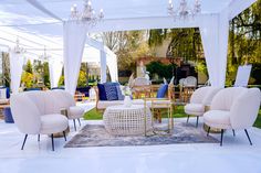 a white tent with chairs and tables in it