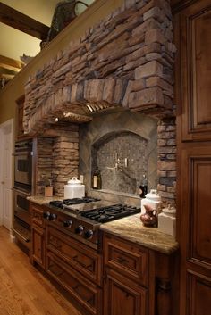 a kitchen with an oven, stove and counter top in the middle of wood flooring