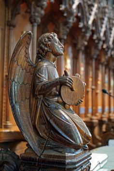 a statue of an angel holding a harp