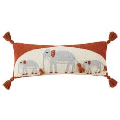 an orange and white pillow with elephants on it