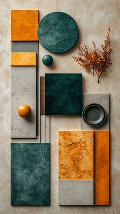 an arrangement of different colors and shapes on a table with oranges, greys, and green