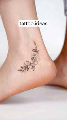 a small flower tattoo on the side of a woman's foot, with text above it