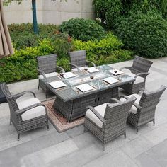 an outdoor dining table and chairs set up outside