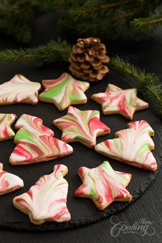 decorated cookies are arranged on a black platter