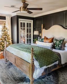 a bedroom decorated for christmas with green and white decor