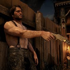 a man holding a knife in front of a wooden fence