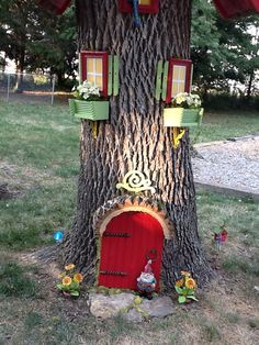 a tree with a little red door in it