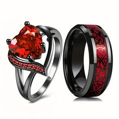 two wedding rings with red and black diamonds on the sides, one has a heart shaped stone