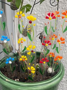 a potted plant with glass flowers in it