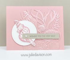 a close up of a card on a table with a white and pink background that says wishing you the very best