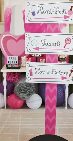 a pink and white sign sitting on top of a table