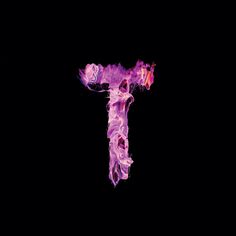 the letter t is made up of purple and pink liquid in the shape of a cross