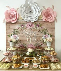 a baby girl dessert table with flowers on it