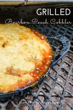 a close up of a pie on a grill with the words grilled bourbon peach cobbler