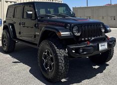 a black jeep parked in front of a building