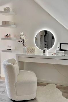 a white chair sitting in front of a desk with a mirror on top of it