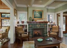 a living room filled with furniture and a fire place in the middle of a room