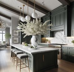 a large kitchen with marble counter tops and green cabinets, along with bar stools