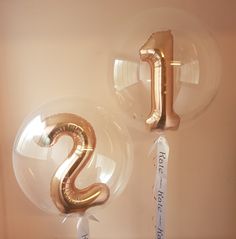 two balloons shaped like the letter s and one that says happy new year on it