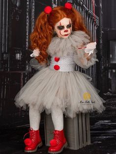 a doll with red hair and makeup is dressed up