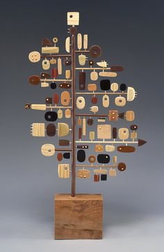 a wooden christmas tree with many different types of items on it's sides and in the shape of an arrow