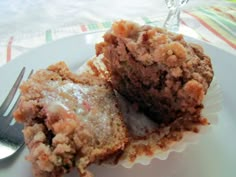 a piece of cake sitting on top of a white plate next to a knife and fork