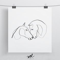 a black and white drawing of two dogs on a sheet of paper hanging from a clothes line