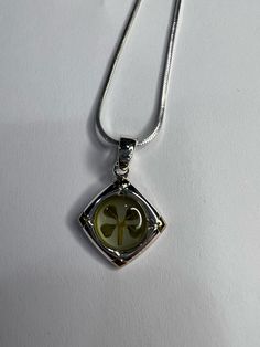 Real four-leaf clover, sterling silver charm. The diameter of the charm is Approximately 1.5cm (about 0.59 in). The necklace is an 18 in sterling silver chain.   This jewelry is perfect for yourself and or as a gift! Whether it's for a birthday, wedding, St. Partrick's day, or just to have; it will always bring you luck. Sterling Silver Charm Necklaces With Hallmarked Round Pendant, Sterling Silver Charm Necklaces With Round Pendant, Classic Silver Jewelry With Flower Charm, Green Sterling Silver Charm Necklace, Green Sterling Silver Necklaces With Charms, Green Sterling Silver Necklace With Charms, Green Sterling Silver Charm Necklace With Round Pendant, Sterling Silver Charm Necklace With Engraved Square Pendant, Nickel-free White Gold Charm Necklace With Round Pendant