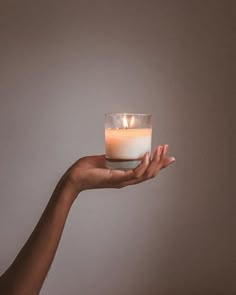 a person holding a lit candle in their hand