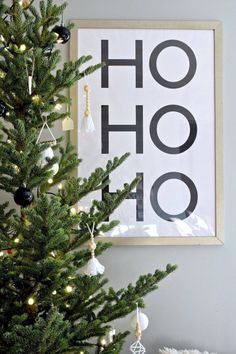 a christmas tree in front of a poster with the words ho hoo on it